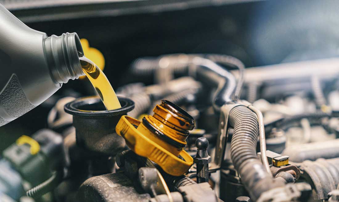 Technician performing a professional auto oil change service in Tulsa, OK